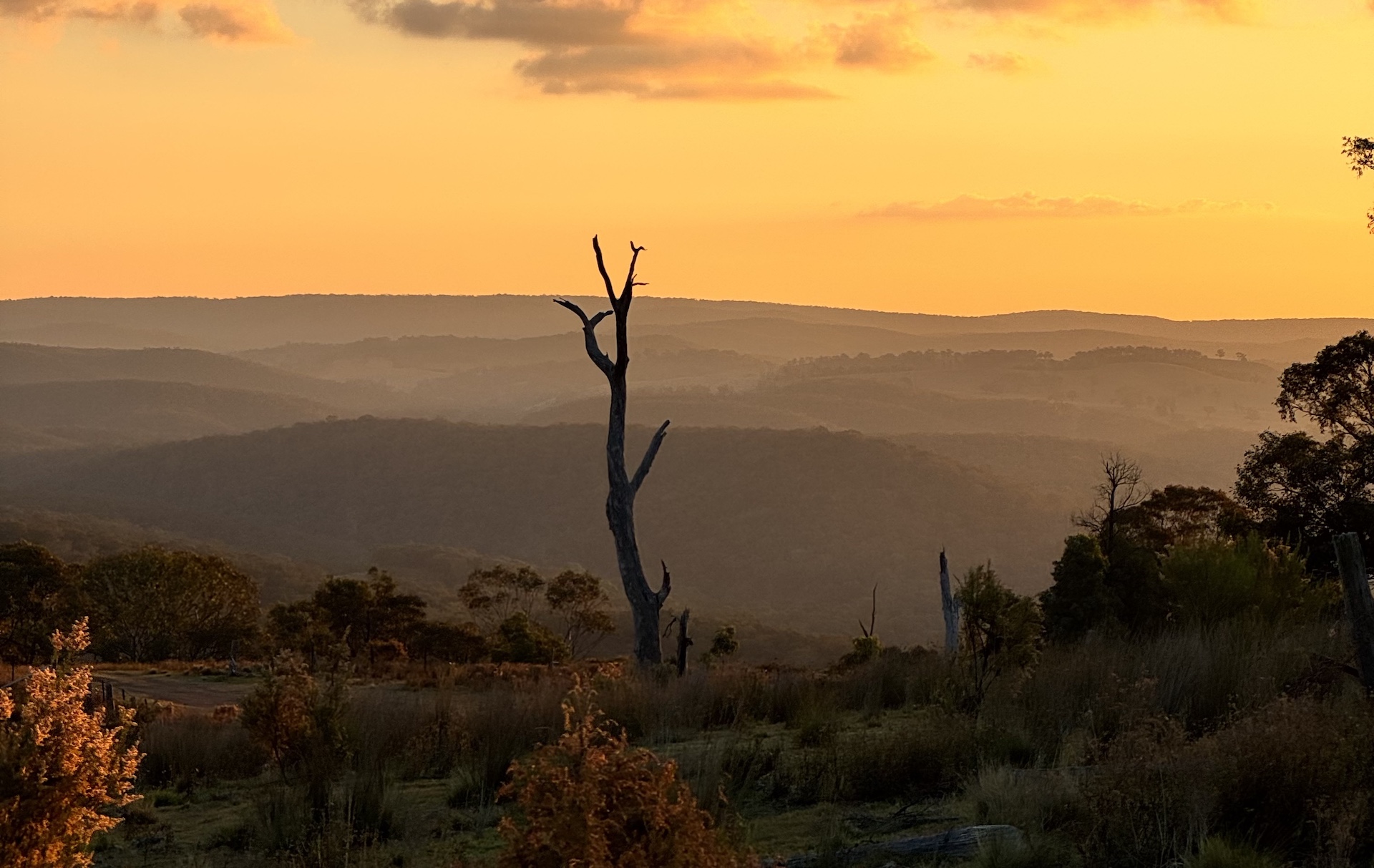 The sunset creating a silhouette across the mountain ranges